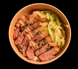 Fried pork in cup paper on black background.