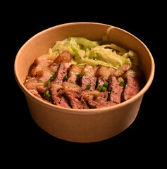 Fried pork in cup paper on black background.