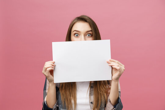 Young Caucasian Woman Holding Blank Paper Sheet Over Isolated Background Scared In Shock With A Surprise Face, Afraid And Excited With Fear Expression