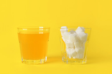 Glasses with sugar and orange juice on color background