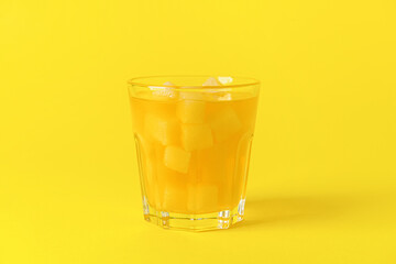 Glass with sugar and orange juice on color background