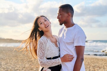 Portrait of a happy young beautiful couple on the beach