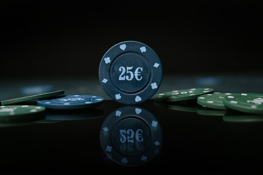 Poker chips on dark background, closeup