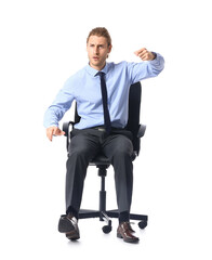 Young man with imaginary steering wheel sitting on chair against white background