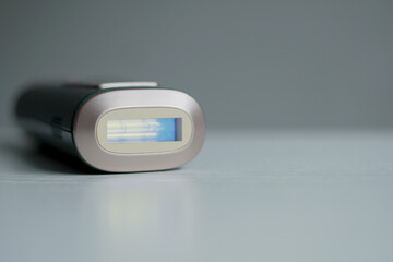 Portable professional laser hair removal with copy space. The portable device provides professional hair removal at home comfort.