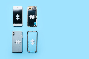 Disassembled mobile phones and puzzles on color background