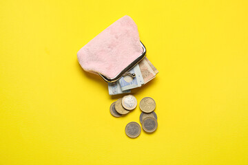 Pink wallet with money on yellow background - obrazy, fototapety, plakaty