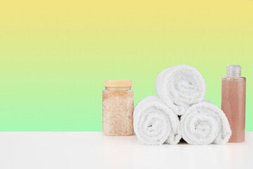 Fototapeta na wymiar Bath towels and spa salt on white table
