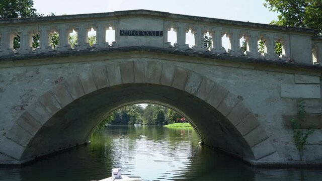 Travel under a small bridge on a small boat on the lake. View from the boat.