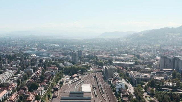 Drone shot over train tracks leading into Bern station Switzerland