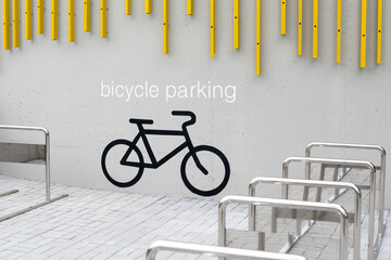 Empty bike parking in city park. Parking space for multiple bikes. Place for parking at the house or shop of bicycles or scooters, environmentally friendly urban transport in the city - Powered by Adobe