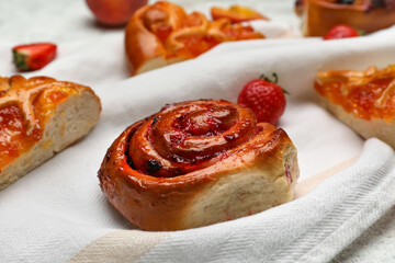 Tasty strawberry bun on napkin, closeup