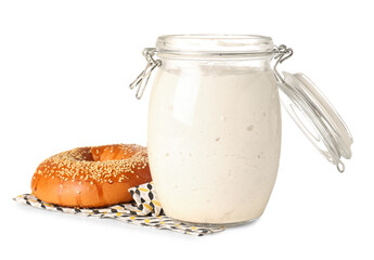 Jar with fresh sourdough and bagel on white background