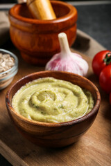 Bowl with tasty baba ghanoush on table, closeup