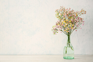 Vase with beautiful gypsophila flowers on table