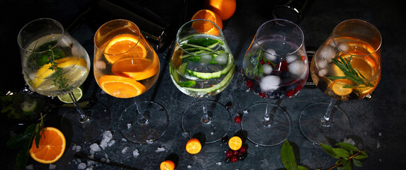 Fototapeta na wymiar Gin cocktails assortment served on dark background.