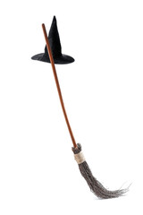 Witch hat and broom isolated on white