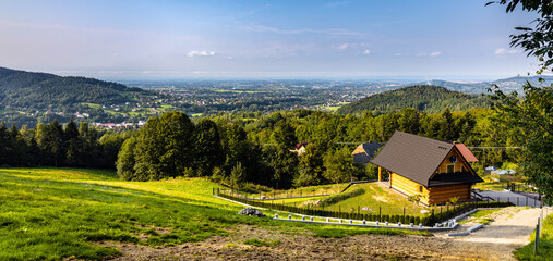 Panoramic view of northern slope of Little Beskids in Beskidy Mountains with wooden village house Targanice village near Andrychow in Lesser Poland