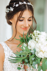 Morning of the bride. Portrait of a sweet bride with a bouquet of flowers