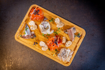 Overhead shot of a smoked table on a black background, sea food, variety of fish and seafood