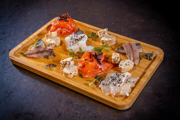 Smoked table on a black background, sea food, variety of fish and seafood