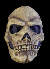Yellowed Skull Mask Isolated Against Black Background