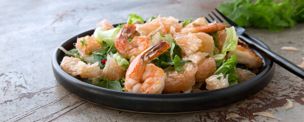 salad plate with pomelo and shrimps on the table