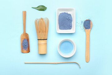 Fototapeta na wymiar Composition with powdered blue matcha tea, chasen and chashaku on color background