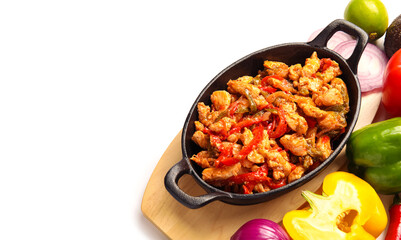 Frying pan with traditional Mexican chicken Fajita and vegetables on white background