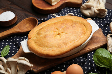 Baking dish with tasty mushroom pot pie on table