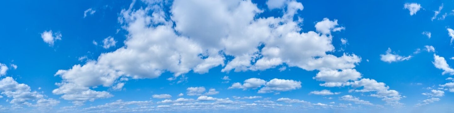 Wide panorama of bright blue sky with clouds