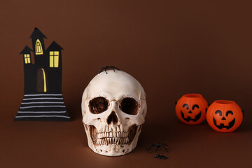 Skull with Halloween decor on color background