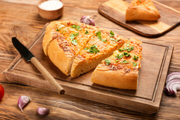 Board with tasty Turkish Pizza on wooden background