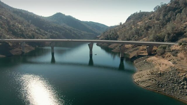 Aerial: Highway over the Don Pedro Reservoir in the foothills of the Sierra Nevada. California, USA