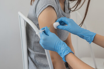 Covid-19, coronavirus asian young woman getting vaccine from doctor or nurse giving syringe shot to arm's patient. Vaccination, immunization, disease prevention against flu or virus pandemic concept.