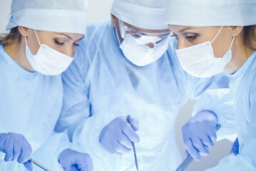 A group of surgeons is operating at the hospital. Health care concept