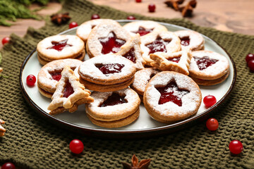 Plate with tasty Linzer cookies on table