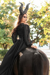 Beautiful woman dressed for Halloween with horse in forest