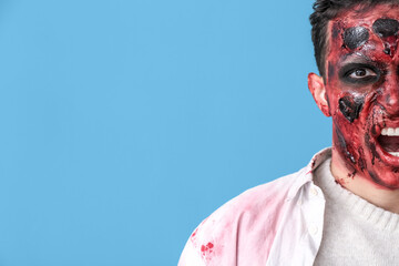 Scary zombie man on color background
