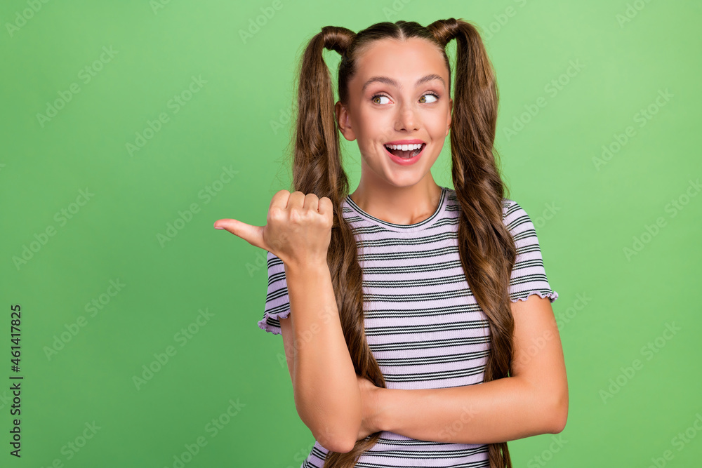 Poster Photo of joyful amazed happy young woman point look thumb empty space sale offers show isolated on green color background