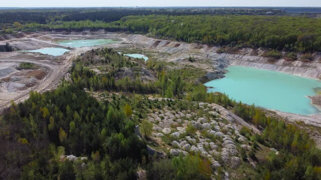 Small turquoise quarry lakes in abandoned kaolin pit, aerial view