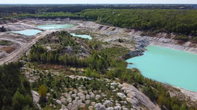 Small turquoise quarry lakes in abandoned kaolin pit, aerial view