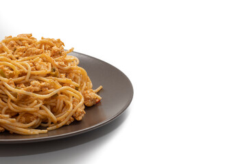 Plate covered with delicious Italian spaghetti, with tomato sauce. Isolated on white background. Healthy life concept.