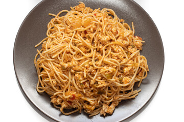 Plate covered with delicious Italian spaghetti, with tomato sauce. Isolated on white background. Healthy life concept.