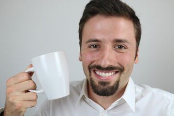 Happy elegant man holding white mug 