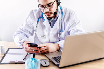 Male doctor using mobile phone at hospital. Medical healthcare and doctor service.