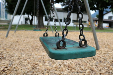 empty swing in school garden  