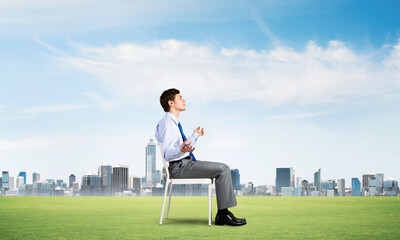 businessman meditates on office chair