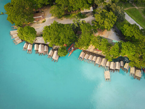 Aerial View Blue Water River, Top View Sea Blue Lagoon Pond Water From Above, Bird Eye View Green Tree And Bamboo Raft House And Wooden Boat On Water Surface Beautiful Fresh Environment Landscape Lake