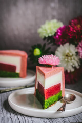 A piece of mousse spinach strawberry cake. Focus on the part  of piece of cake. 